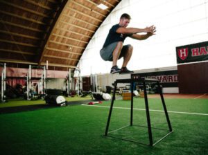 Athlete practicing box jump: a plyometric exercise for functional strength